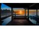 Covered dock features swing and sunset views at 5243 W Lake Butler Rd, Windermere, FL 34786