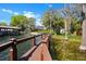 View down the dock leading to the house and a boat house, surrounded by water at 5243 W Lake Butler Rd, Windermere, FL 34786