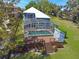 Aerial view of a well-maintained house with a pool, expansive deck, and manicured lawn, ideal for outdoor living at 5243 W Lake Butler Rd, Windermere, FL 34786