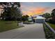 Stunning two-story home with a gray exterior, a white metal roof and an expansive driveway at 5243 W Lake Butler Rd, Windermere, FL 34786