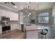 Open concept kitchen with white cabinets, granite countertops, and a view of the living room and lake at 5243 W Lake Butler Rd, Windermere, FL 34786