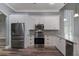 Modern kitchen featuring stainless steel appliances, granite countertops, white cabinets, and wood flooring at 5243 W Lake Butler Rd, Windermere, FL 34786