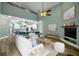 Staged living room featuring an open layout, modern furnishings, and a view of the kitchen with bar seating at 5243 W Lake Butler Rd, Windermere, FL 34786