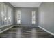 Bright living room showcasing shuttered windows and hardwood floors at 5243 W Lake Butler Rd, Windermere, FL 34786