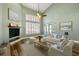 Staged living room with vaulted ceilings, wood floors, neutral-toned furniture, and natural light from the windows at 5243 W Lake Butler Rd, Windermere, FL 34786