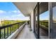 A spacious tiled balcony with a railing and sliding glass doors showcases the surrounding views at 530 E Central Blvd # 705, Orlando, FL 32801