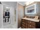 Elegant bathroom vanity with decorative tile wall and walk-in closet in the background at 530 E Central Blvd # 705, Orlando, FL 32801