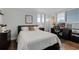 Bedroom with hardwood floors, comfortable bed, and windows with shutters at 530 E Central Blvd # 705, Orlando, FL 32801