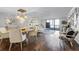 Open-concept dining area featuring modern lighting, stylish furniture, and hardwood flooring at 530 E Central Blvd # 705, Orlando, FL 32801