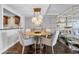 Dining room featuring a modern table, chairs and a gold shelving unit between living area at 530 E Central Blvd # 705, Orlando, FL 32801