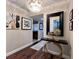 Elegant condo hallway featuring art, a modern console table, wood floors and a decorative chandelier at 530 E Central Blvd # 705, Orlando, FL 32801