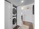 Hallway featuring stacked washer and dryer tucked away behind a closet door at 530 E Central Blvd # 705, Orlando, FL 32801