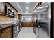 Well-equipped kitchen with stainless steel appliances, dark cabinets, and granite countertops at 530 E Central Blvd # 705, Orlando, FL 32801