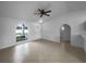 Bright living room featuring tiled floors, a ceiling fan and an arched front window at 546 Koala Dr, Kissimmee, FL 34759