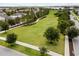 Aerial view of the community with an expansive green space, and well-maintained landscaping at 6633 Calamondin Dr, Winter Garden, FL 34787