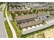 This aerial showcases the townhome community's layout with multiple units, streets, and green spaces at 6633 Calamondin Dr, Winter Garden, FL 34787