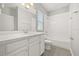 Clean and well-lit bathroom featuring white vanity and a tub with a shower head at 6633 Calamondin Dr, Winter Garden, FL 34787