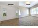 A bright bedroom shows before and after renovations, including fresh paint and new carpet at 6633 Calamondin Dr, Winter Garden, FL 34787