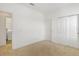 Neutral bedroom featuring plush carpet, double sliding door closet, and a laundry room entrance at 6633 Calamondin Dr, Winter Garden, FL 34787