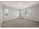 Bright, empty bedroom with carpeted floors, neutral walls, and windows providing ample natural light at 6633 Calamondin Dr, Winter Garden, FL 34787