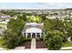 An aerial view of a neighborhood clubhouse with picturesque landscaping, a manicured lawn and a sidewalk at 6633 Calamondin Dr, Winter Garden, FL 34787