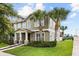 Beautiful two-story home with a well-manicured lawn, decorative stone accents, and inviting entryway at 6633 Calamondin Dr, Winter Garden, FL 34787