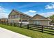 Two-story home featuring a black fence and lush green lawn at 6633 Calamondin Dr, Winter Garden, FL 34787