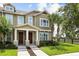 Charming home exterior featuring a well-maintained lawn, inviting entryway, and beautiful palm trees at 6633 Calamondin Dr, Winter Garden, FL 34787