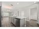 Modern kitchen with a quartz island, stainless steel appliances, hardwood floors, and an open layout at 6633 Calamondin Dr, Winter Garden, FL 34787