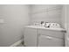 Bright laundry room features stacked washer and dryer and a wire rack shelf at 6633 Calamondin Dr, Winter Garden, FL 34787