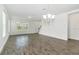 Bright living room showcasing wood-look flooring, a chandelier, and abundant natural light at 6633 Calamondin Dr, Winter Garden, FL 34787