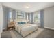 Calm main bedroom featuring neutral walls, carpeted flooring, and windows dressed with flowing blue drapes at 6633 Calamondin Dr, Winter Garden, FL 34787