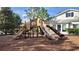 A colorful playground with slides and climbing structures nestled in a well-maintained mulch area at 6633 Calamondin Dr, Winter Garden, FL 34787