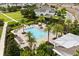 Aerial view of the community pool with lounge chairs, umbrellas, and lush landscaping at 6633 Calamondin Dr, Winter Garden, FL 34787