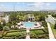 Aerial view of a community pool with lounge chairs, landscaping, and a nearby clubhouse at 6633 Calamondin Dr, Winter Garden, FL 34787