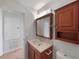 Classic bathroom with a wooden vanity, medicine cabinet, and neutral tones at 760 Park Ave, Orange City, FL 32763