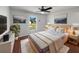 Bright bedroom features a ceiling fan, wood floors, and beach-themed wall art at 760 Park Ave, Orange City, FL 32763