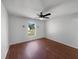 Bright bedroom featuring wood floors, a ceiling fan, and ample natural light at 760 Park Ave, Orange City, FL 32763