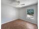 Bright bedroom with neutral walls, a ceiling fan, and a large window for natural light at 760 Park Ave, Orange City, FL 32763