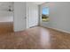 Cozy bedroom featuring wood-look floors, double door closet, and a bright window at 760 Park Ave, Orange City, FL 32763