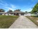 Charming single-story home with a well-manicured lawn and attached two-car garage at 760 Park Ave, Orange City, FL 32763