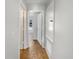 Hallway featuring tile floors, white walls, and access to other rooms in the home at 760 Park Ave, Orange City, FL 32763