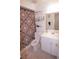 Clean bathroom with a vanity, toilet, and shower with decorative curtain at 763 Royal Palm Dr, Kissimmee, FL 34743