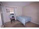 Simple bedroom with a bed, window, and minimal furnishings at 763 Royal Palm Dr, Kissimmee, FL 34743