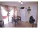 Cozy dining area with sliding glass doors to the patio, adjacent to the kitchen and living space at 763 Royal Palm Dr, Kissimmee, FL 34743