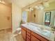 The bathroom features dual sinks with great lighting and a walk in shower at 7732 Sloewood Dr, Leesburg, FL 34748