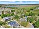 Aerial view showcasing houses with solar panels, swimming pools, and surrounded by trees in a residential community at 9649 Water Fern Cir, Clermont, FL 34711