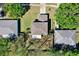 Aerial view of a home featuring a well-maintained yard with mature trees and neighboring properties at 9649 Water Fern Cir, Clermont, FL 34711