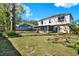 Expansive backyard featuring lush green grass, a screened-in porch and fenced boundary at 9649 Water Fern Cir, Clermont, FL 34711