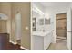 Bathroom featuring white vanity with arched doorway leading to other rooms at 9649 Water Fern Cir, Clermont, FL 34711